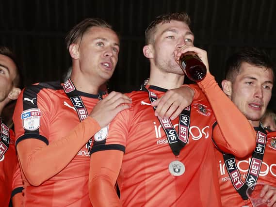 Former Luton defender Jack Stacey celebrates winning promotion with the Hatters
