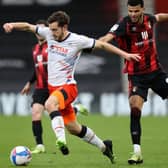 Tom Lockyer gets to the ball ahead of Bournemouth striker Dominic Solanke