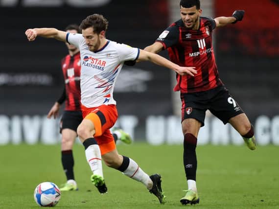 Tom Lockyer gets to the ball ahead of Bournemouth striker Dominic Solanke