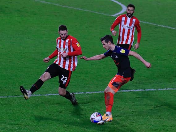 Dan Potts delivers a cross against Brentford on Wednesday night
