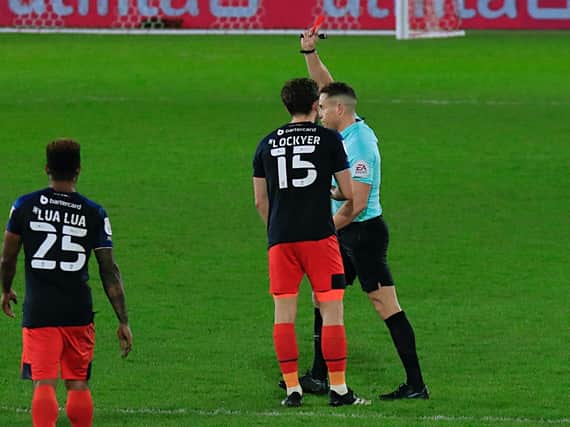 Tom Lockyer is shown red by referee Stephen Martin against Brentford