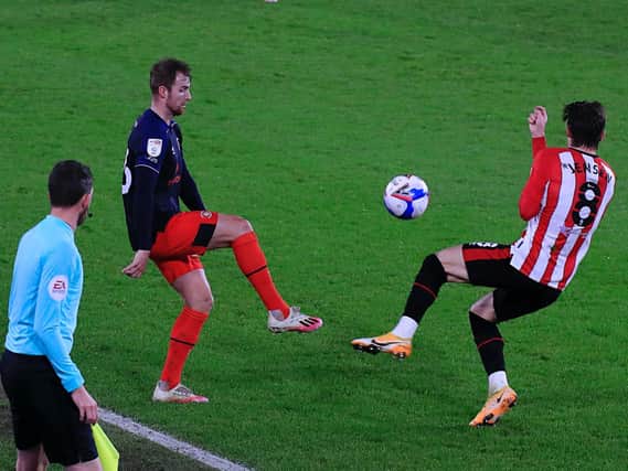 James Bree gets to the ball against Brentford