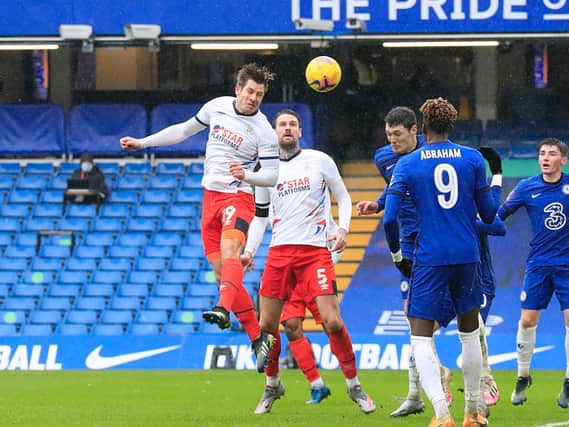 James Collins gets a header in during the 3-1 defeat at Chelsea on Sunday