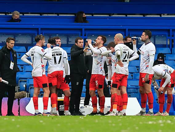 Nathan Jones addresses his Luton players during a break in play at Stamford Bridge