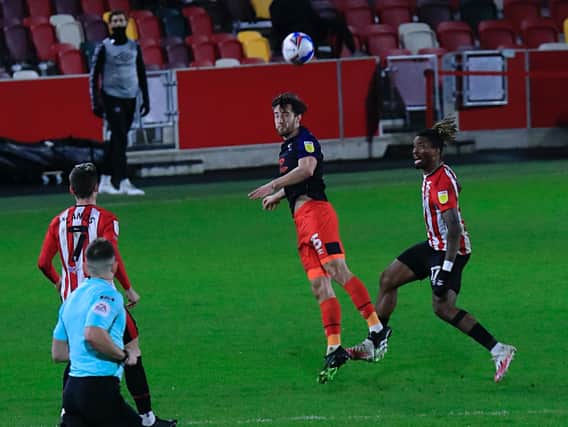 Tom Lockyer heads clear during Town's 1-0 defeat at Brentford recently