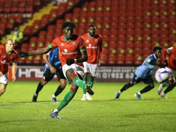 Elijah Adebayo scores one of his 10 goals for Walsall this season
