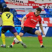 Town defender Tom Lockyer wins the ball against Huddersfield recently