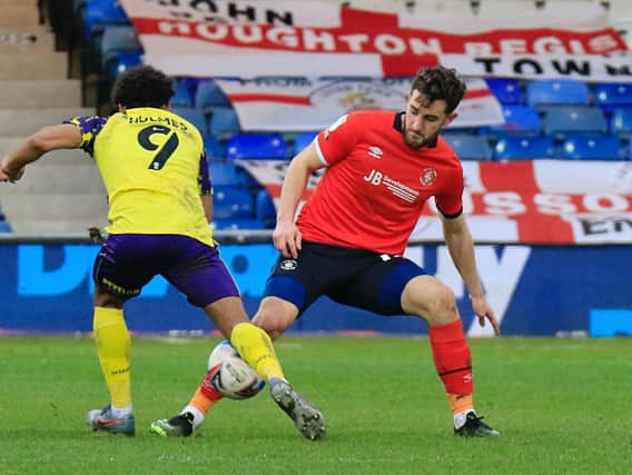 Town defender Tom Lockyer wins the ball against Huddersfield recently