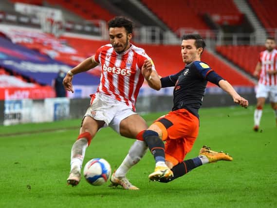 Dan Potts slides in to make a challenge during Luton's 3-0 defeat at Stoke this afternoon