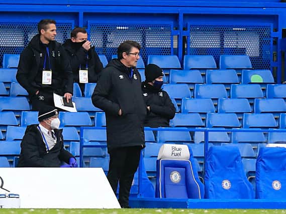 Town assistant boss Mick Harford watches on from the sidelines