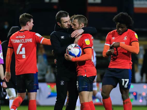 Nathan Jones gives Jordan Clark a hug after Tuesday night's win over Coventry City