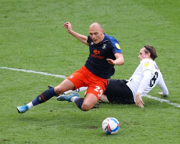 Kal Naismith is felled during Luton's 2-0 defeat at Derby