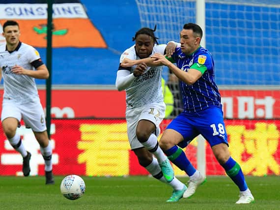 Pelly-Ruddock Mpanzu challenges for possession at Wigan on Saturday