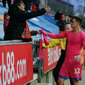 Simon Sluga gives his shirt to a Luton fan after the 0-0 draw at Wigan on Saturday