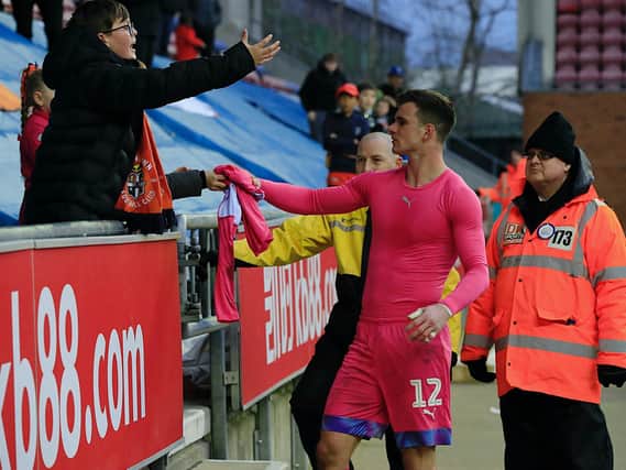 Simon Sluga gives his shirt to a Luton fan after the 0-0 draw at Wigan on Saturday