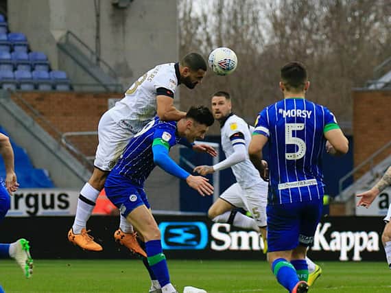 Cameron Carter-Vickers gets up to head clear against Wigan
