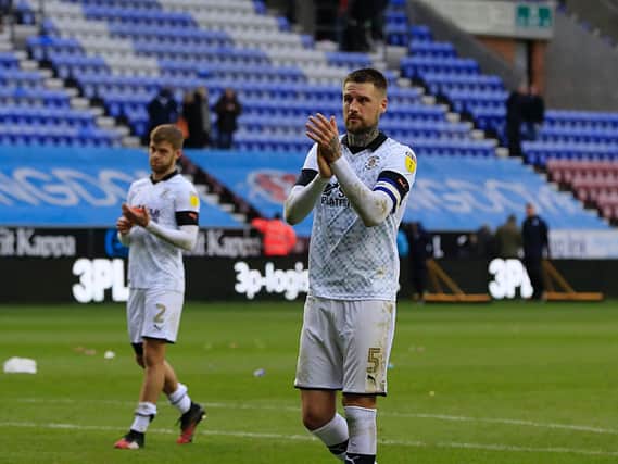 Sonny Bradley applauds the travelling fans at Wigan on Saturday