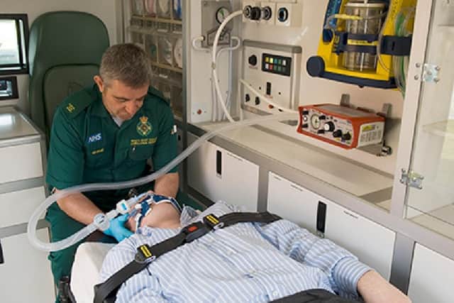 A paramedic uses the PARAPAC Plus ventilator on a patient