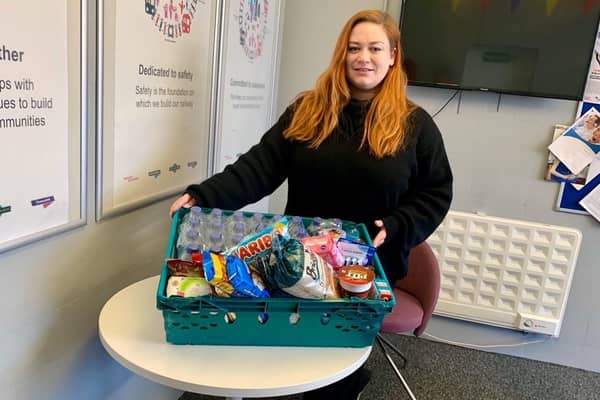 Thameslink passenger host Eloise Rowan with a crate of donations. (C) Govia Thameslink Railway