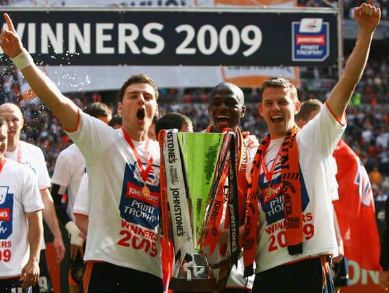 Tom Craddock celebrates winning the Johnstone's Paint Trophy with fellow goalscorers Chris Martin and Claude Gnakpa