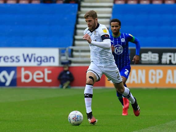 Martin Cranie gets forward during Luton's last match against Wigan Athletic over a month ago