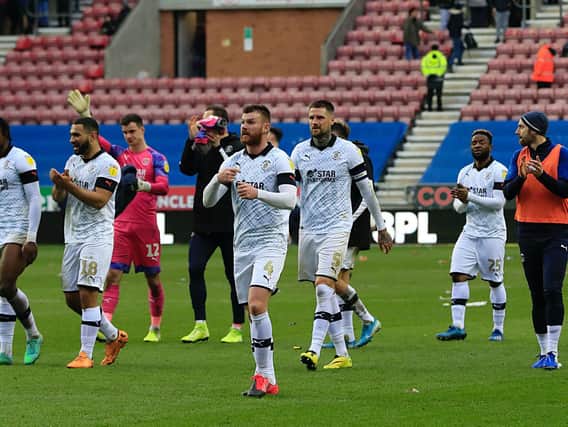 Luton's players applaud their supporters at Wigan during the club's last match before the the season was suspended