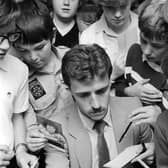 David Moss pictured signing autographs for Luton Town supporters during his playing days