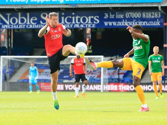 George Moncur goes in for a challenge against Preston