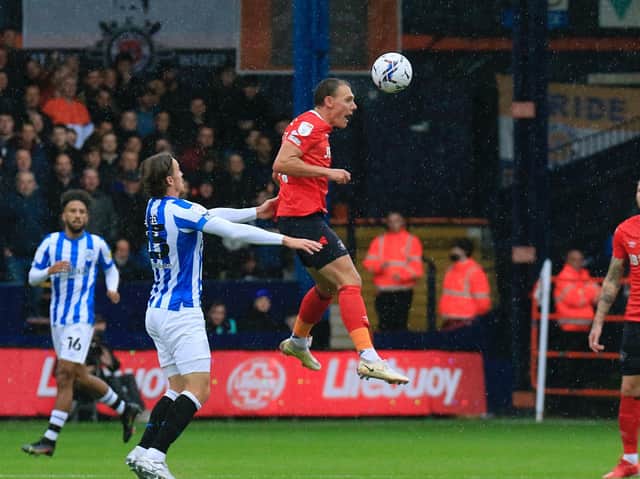 Town defender Kal Naismith wins a header against Huddersfield on Saturday