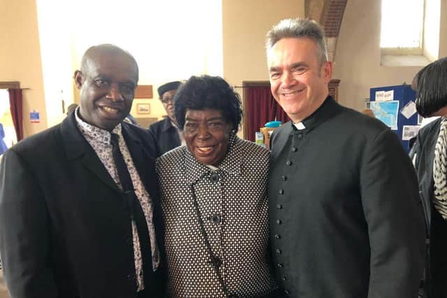 The late Mrs Daphne Palmer pictured at a recent Windrush event with Bob Baker (left) of the Heritage Association and Rev David Kesterton of All Saints