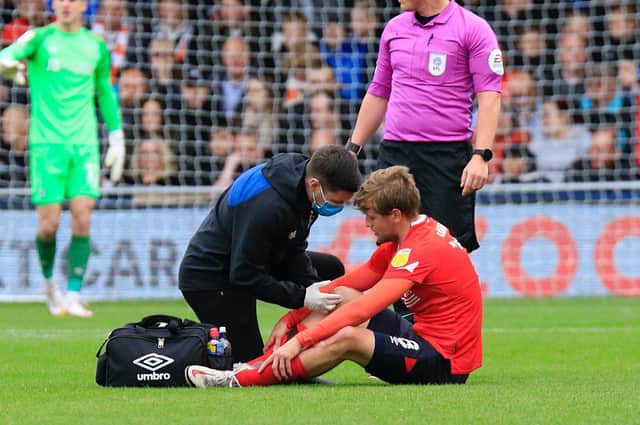 Luke Berry receives treatment during Town's 1-0 win over Hull City
