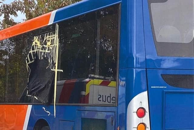 One of the damaged buses after a missile was thrown at the window