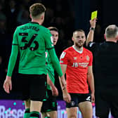 Allan Campbell receives a questionable booking from Premier League official Jonathan Moss on Saturday