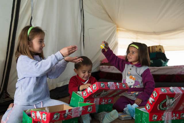 Refugees with their donated Shoeboxes