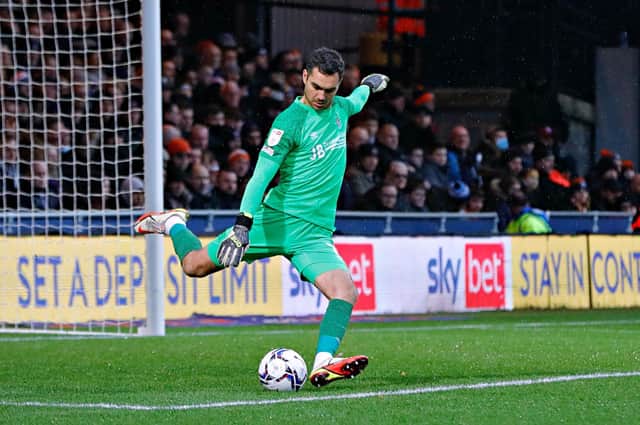 Town keeper James Shea clears his lines against Fulham