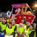 Santa Claus and the Rotary Club volunteers.