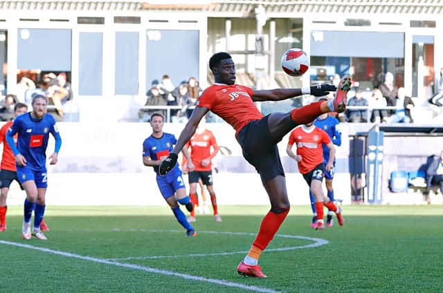 Town forward Elijah Adebayo stretches to control against Harrogate on Sunday