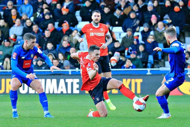 Kal Naismith slides in to win the ball back for Luton