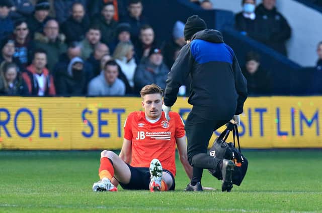 Luton defender Reece Burke gets treatment during the 3-2 win over Bournemouth on Saturday
