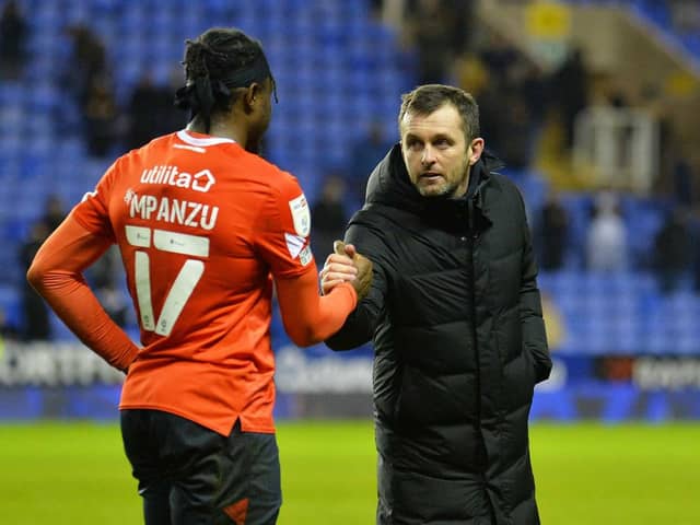 Pelly-Ruddock Mpanzu is congratulated by manager Nathan Jones following Last night's 2-0 win at Reading - pic: Gareth Owen