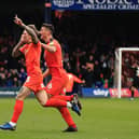 Jason Cummings celebrates scoring for the Hatters