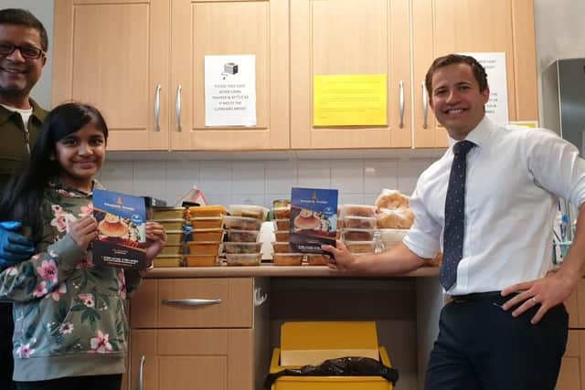 Motin Miah with food parcels at The Lea Primary in Harpenden with the Head of School, Mr Berry, and daughter Samira Miah