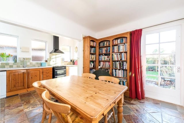The kitchen/breakfast room has a range of fitted bookshelves and a further door to the rear garden