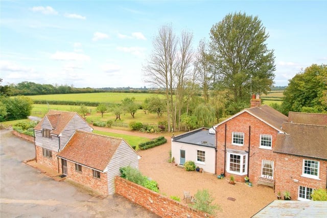 The property offers a range of outbuildings with panoramic views