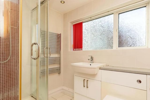 The communal bathroom includes: a wc, a wash hand basin, a heated towel rail, a shower cubicle, tiling to splashback areas, tiled flooring, and a double glazed window.