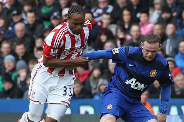 Cameron Jerome goes up against Manchester United's Wayne Rooney during his time at Stoke City