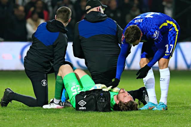 Jed Steer gets treatment after suffering an Achilles injury against Chelsea last night