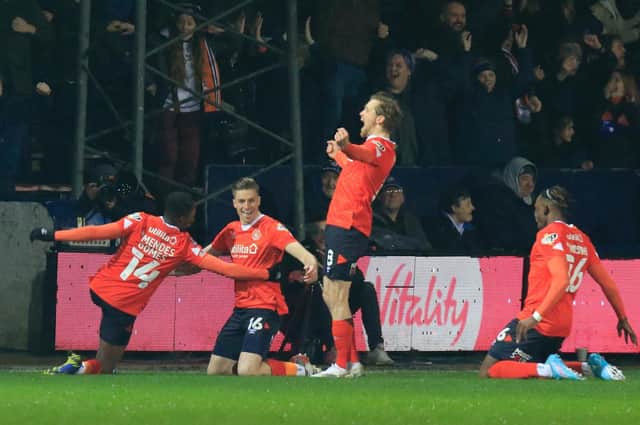 Luton's players celebrate Reece Burke's early header against Chelsea on Wednesday night