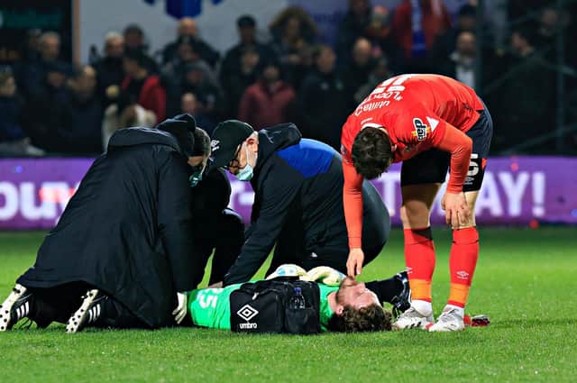 Jed Steer receives treatment during the Hatters' FA Cup defeat to Chelsea