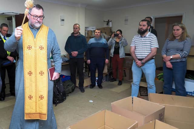 Father Mykola Matwijiwskyj the Ukrainian priest arrived and blessed the donations and those who had toiled to sort and pack them. Photo: Tony Margiocchi